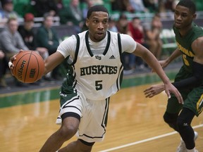U of S Huskies guard  Lawrence Moore goes to move the ball past Regina Cougars guard Brandon Tull during the game at the PAC in Saskatoon, February 2, 2018.