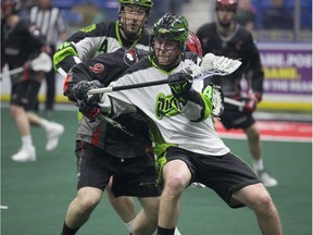 Saskatchewan Rush forward Dan Taylor carries the ball past Vancouver Stealth defender Cody Teichroeb in NLL action Saturday at SaskTel Centre in Saskatoon.