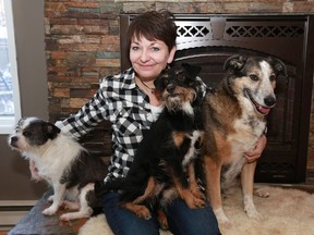 Hayley Hesseln, who pulled a woman out of the river saving her life Sunday, sits with her dogs Maude, Mickey and Jack in her home in Saskatoon on February 5, 2018.