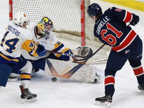 Saskatoon Blades' goaltender Nolan Maier blocks a shot from Regina Pats' Jesse Gabrielle during first-period action in Saskatoon at SaskTel Centre on February 11, 2018.