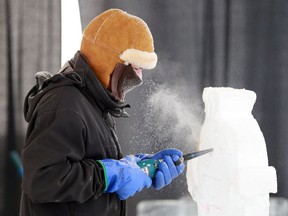 An ice carver from the Professional Ice Carving Society of Saskatoon creates a minion at Frosted Gardens at the Saskatoon Forestry Farm Park & Zoo on February 11, 2018.