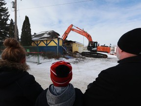 A crowd gathers to watch the demolition of the old Saskatoon Hilltops clubhouse.