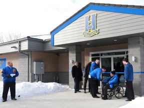 Don McDonald cuts the ribbon during the official opening of the new Saskatoon Hilltops clubhouse on February 20, 2018.