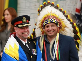 Saskatoon's newest police chief Troy Cooper is wrapped in a blanket by Saskatoon Tribal Council Chief Mark Arcand after being officially sworn in on February 28, 2018.