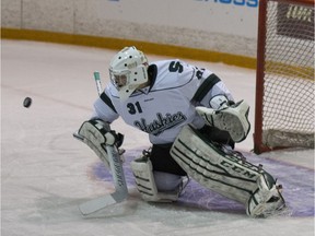 University of Saskatchewan Huskies goalie Taran Kozun steers the puck to the corner at Rutherford Rink in Saskatoon, SK on Saturday, October 7, 2017.