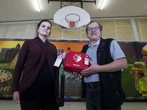 Danielle Borix and Tim Yee stand in the spot on Friday, Feb. 16, 2018, where they used an Automated External Defibrillator (AED) to help save the life of a man who collapsed from a heart attack at a Valentine's Day round dance two days earlier at the Saskatoon Indian and Metis Friendship Centre.