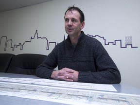 Brent Penner, executive director of Downtown Saskatoon, the downtown business improvement district, looks over City of Saskatoon plans on Friday, Feb. 16, 2018, for a bus rapid transit system that could drastically alter Third Avenue downtown.