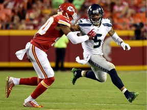 B.J. Daniels #5 of the Seattle Seahawks carries the ball as cornerback Steven Nelson #20 of the Kansas City Chiefs defends during the preseason game at Arrowhead Stadium on August 21, 2015 in Kansas City, Missouri.