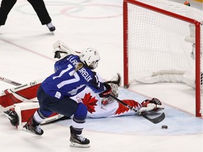 Jocelyne Lamoureux scores on Canadian goaltender Shannon Szabados to give the United States a shootout victory — and the gold medal — in Winter Olympics women's hockey on Thursday.