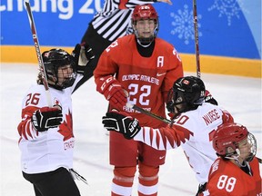 Canada's Emily Clark (L) celebrates a goal in the women's semi-final ice hockey match between Canada and the Olympic Athletes from Russia during the Pyeongchang 2018 Winter Olympic Games at the Gangneung Hockey Centre in Gangneung on February 19, 2018.