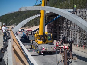 Crews install an open span wildlife overpass at Kicking Horse Pass on the Trans-Canada Highway in 2017. A conservation group based in Canmore would like to see a similar overpass near Lac Des Arcs, Alta., to prevent wildlife-vehicle collisions. THE CANADIAN PRESS/HO-Ross Donihue/Yellowstone to Yukon MANDATORY CREDIT