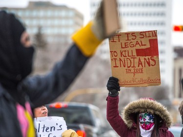 Protesters wave signs at vehicles driving along Victoria Avenue outside of Regina's Queen's Bench Court on Feb. 10, 2018, the day after Gerald Stanley was acquitted of all charges relating to the shooting death of Colten Boushie.