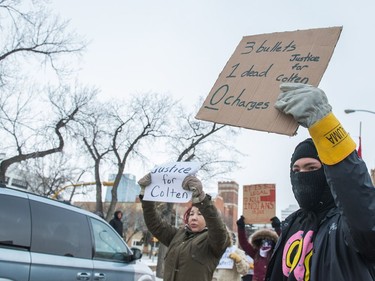 Protesters wave signs at vehicles driving along Victoria Avenue outside of Regina's Queen's Bench Court on Feb. 10, 2018, the day after Gerald Stanley was acquitted of all charges relating to the shooting death of Colten Boushie.