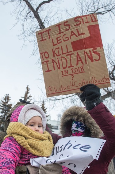 A protester waves a sign on Victoria Avenue outside of Regina's Queen's Bench Court on Feb. 10, 2018, the day after Gerald Stanley was acquitted of all charges relating to the shooting death of Colten Boushie.