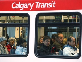 Commuters cram onto a crowded C-Train car in the early hours of rush hour in Calgary on October 28, 2009.