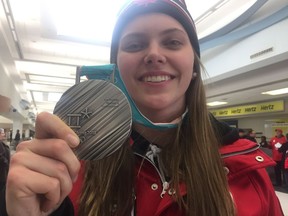 Saskatoon's Emily Clark shows off her silver medal after arriving back home from the 2018 PyeongChang Olympics in South Korea.