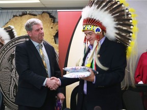 President of the Saskatchewan School Boards Association Shawn Davidson, left, and Chief Bobby Cameron exchange gifts after signing a Memorandum of Understanding on "Reconciliation Through Treaty Education" in Saskatoon, SK on Friday, February 2, 2017.