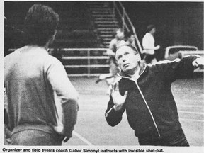 Gabor Simonyi works with a shot-putter in a photo from The Gateway, the University of Alberta's student paper.