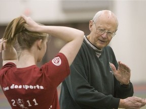 Lyle Sanderson coaches an athlete in high jump in 2011.