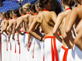 FILE - In this file photo dated Saturday, May 27, 2017, so called "grid girls" line up after the qualifying session for the Formula One Grand Prix at the Monaco racetrack in Monaco.   Formula One says it is ending the practice of using "grid girls" and "podium girls" at races, with F1 managing director of commercial operations Sean Bratches saying Wednesday Jan. 31, 2018, the use of the women on the grid is clearly "at odds with modern day societal norms."