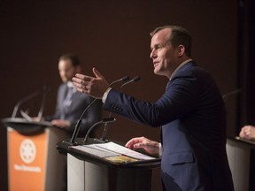 Trent Wotherspoon (right) answers a question as Ryan Meili (left) listens during the first debate for the Saskatchewan's NDP's leadership race at TCU Place in Saskatoon on Thursday, Feb. 15, 2018. MLA Vicki Mowat moderated.