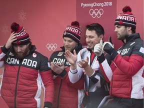 Canada's Ben Coakwell, left, Nick Poloniato, Cameron Stones and Joshua Kirkpatrick watch their fellow team members on a screen during the four-man bobsled at the Olympic sliding centre during the 2018 Winter Olympics in Pyeongchang, South Korea, Sunday, Feb. 25, 2018.