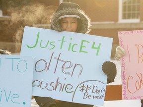 Grade 7 and 8 students from the Piyesiw Awasis School on the Thunderchild First Nation hold signs outside of the Court of Queen's Bench on the day of closing arguments in the trial of Gerald Stanley, the farmer accused of killing 22-year-old Indigenous man Colten Boushie, in Battleford, Sask. on Thursday, February 8, 2018.