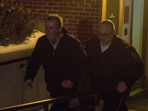 Gerald Stanley leaves the Court of Queen's Bench out a back door with members of the RCMP after a jury delivered a verdict of not guilty of killing 22-year-old Indigenous man Colten Boushie, in Battleford, Sask., Friday, February 9, 2018.