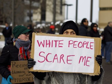 A women holds a sign during a rally in response to Gerald Stanley's acquittal in the shooting death of Colton Boushie in Edmonton, Alta., on Saturday, February 10, 2018.