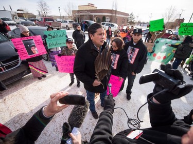 Alvin Baptiste, Colten Boushie's uncle, addresses the media as he stands with Colten's mother Debbie Baptiste and brother Jace Boushie as demonstrators gather outside of the courthouse in North Battleford, Sask., on Saturday, February 10, 2018.