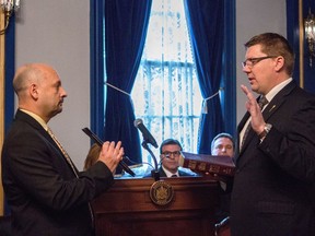 Incoming Saskatchewan premier Scott Moe, right, is sworn-in during a ceremony at Government House, in Regina on Friday, February 2, 2018.