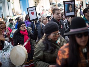 People listen to speakers during a rally for Tina Fontaine in Vancouver, B.C., on Saturday February 24, 2018. A review by Manitoba's children's advocate into the death of Tina Fontaine is almost complete, but may not be made public. The 15-year-old girl's body was found in a Winnipeg river in 2014 after she ran away from child welfare workers, and Indigenous leaders say the public needs to know how the system failed her.THE CANADIAN PRESS/Darryl Dyck