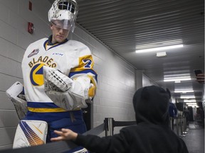 Saskatoon Blades goalie Nolan Maier greets a fan on the way to the locker-room at SaskTel Centre.