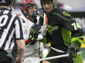 Vancouver Stealth transition Brendan Fowler fights for the ball with Saskatchewan Rush defender Jeremy Thompson during the game at SaskTel Centre in Saskatoon, March 3, 2018.