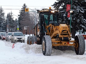 City workers clear snow off of Taylor Street, after a heavy snowfall in Saskatoon on March 6, 2018.