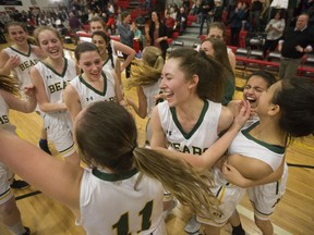 Aden Bowman Bears players celebrate after winning the city girls high-school basketball title Saturday night.
