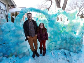 Steve Kasstan and his eight-year-old daughter Sonia Kasstan stand under an archway of their blue ice fort they built over the course of the winter in Saskatoon, SK on March 21, 2018.