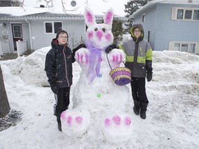 Twin brothers Aaron, left, and Joel Repski, age 12, built a snow bunny in front of their home on Hilliard Street East in Saskatoon, on March 27, 2017.