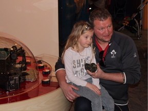 Jon Ganshorn and his daughter Lily pose with the rare ammonite fossil they uncovered at Lake Diefenbaker which will now become part of the collection at the Royal Saskatchewan Museum. (supplied)