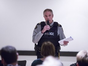 RCMP Staff Sgt. Greg Abbott addresses a town hall meeting in Biggar, about 100 kilometres west of Saskatoon, Monday night.