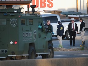 Law enforcement officials search for evidence at the location where the suspected package bomber was killed in suburban Austin on March 21, 2018 in Round Rock, Texas.