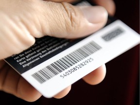 A man holds a customer card with a bar code in Gelsenkirchen, Germany, Thursday, Sept. 4, 2008. There are signs that the days of the barcode are numbered as technological improvements allow companies to replace them with more secure digital options.