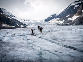 People walk on the Athabasca Glacier in a handout photo. Researchers say that running climate models at higher levels are allowing them to look at the impact of severe storms with more accuracy. THE CANADIAN PRESS/HO