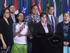 Senator Kim Pate stands with advocates and family members of Colten Boushie, rear left to right, Eleanore Sunchild, Sheldon Wuttunee, Debbie Baptiste, mother of Colten Boushie, Alvin Baptiste, uncle of Colten Boushie, Senator Kim Pate, lawyer Chris Murphy, and Jade Tootoosis, cousin of Colten Boushie, as she speaks during a press conference on Parliament Hill in Ottawa on February 14, 2018. When Gerald Stanley testified in a Saskatchewan court last month he told a jury his version of what happened on the summer day in 2016 when Colten Boushie, a young Indigenous man, was fatally shot. People heard Stanley's story in court or followed it across Canada in news reports. Boushie's cousin, Jade Tootoosis, says the 22-year-old from Red Pheasant First Nation will never get that same opportunity.