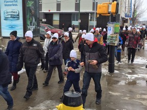 Participants of the March a Mile Walk to End Homelessness make their way out of the Lighthouse Supported Living Centre and up 2nd Avenue in Saskatoon on March 24, 2018. (Erin Petrow/ Saskatoon StarPhoenix)