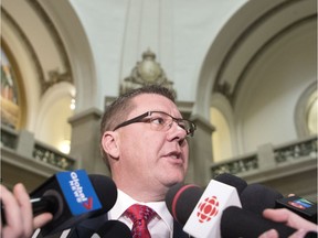 Premier Scott Moe speaks with reporters in the rotunda at the Legislative Building in Regina.