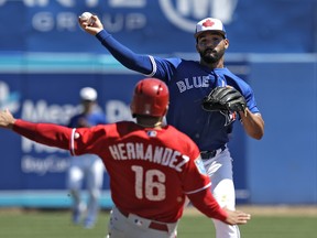 Toronto Blue Jays second baseman Devon Travis throws to first base against the Philadelphia Phillies on March 21.