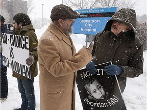 People on opposite sides of the abortion debate demonstrate in front of City Hospital in February 2013.