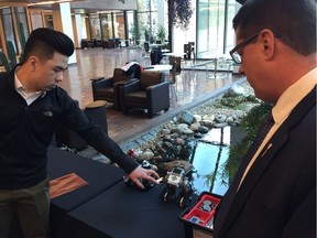 Kevin Chung, program specialist at Innovation Saskatchewan, shows MLA Eric Olauson some examples of robots that Saskatchewan students will soon have the opportunity to learn how to create and code at Innovation Place in Saskatoon on March 23, 2018. (Erin Petrow/ Saskatoon StarPhoenix)