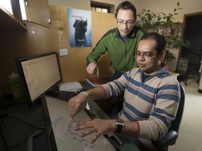 Researchers Mohammad Sami Uddin and Carl Gutwin (left) use their new, faster HandMark-Finger menu developed for smart TVs, computer desktops and tablets.